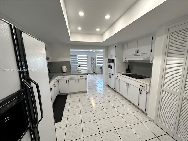 8821 SW 87th St, Miami, FL 33173 - kitchen featuring oven, black electric stovetop, a peninsula, white cabinets, and recessed lighting