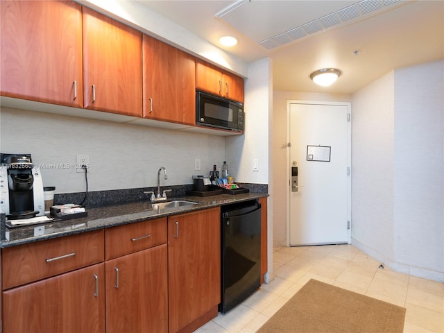 18001 Collins Ave Unit 1107, Sunny Isles Beach, FL 33160 - kitchen featuring black appliances, dark stone countertops, brown cabinets, and tasteful backsplash