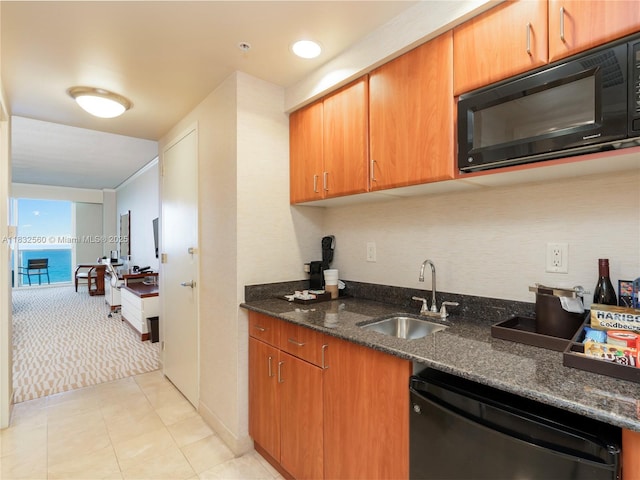 18001 Collins Ave Unit 1107, Sunny Isles Beach, FL 33160 - kitchen featuring dishwasher, black microwave, dark stone countertops, light colored carpet, and light tile patterned floors