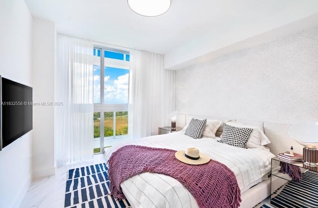 2000 Metropica Way Unit 2102, Sunrise, FL 33323 - bedroom with baseboards and marble finish flooring