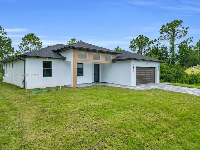 1018 Calvin Ave, Lehigh Acres, FL 33972 - prairie-style home with stucco siding, a garage, concrete driveway, and a front yard