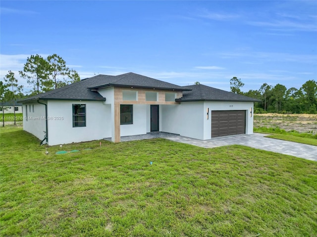 1018 Calvin Ave, Lehigh Acres, FL 33972 - prairie-style home featuring stucco siding, an attached garage, driveway, and a front yard