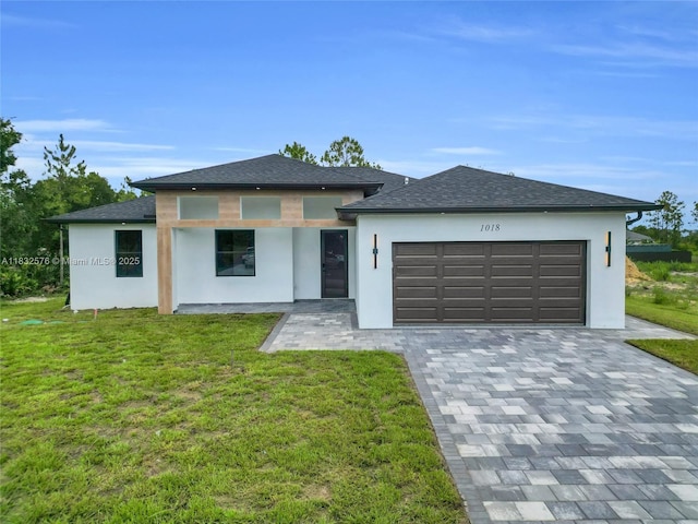 1018 Calvin Ave, Lehigh Acres, FL 33972 - prairie-style house with stucco siding, a garage, and a front yard