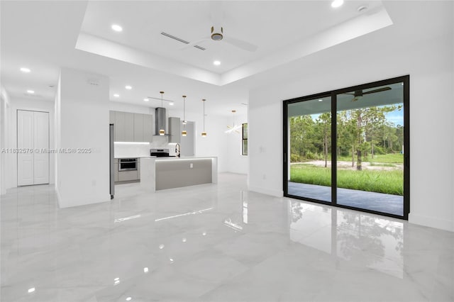 1018 Calvin Ave, Lehigh Acres, FL 33972 - unfurnished living room with a raised ceiling, ceiling fan, light marble finish flooring, and recessed lighting