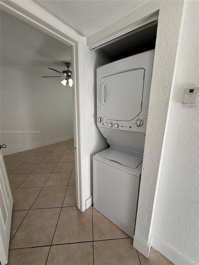 6515 W 27th Ct Unit 49-12, Hialeah, FL 33016 - washroom featuring stacked washer / dryer, a ceiling fan, tile patterned flooring, a textured ceiling, and a textured wall