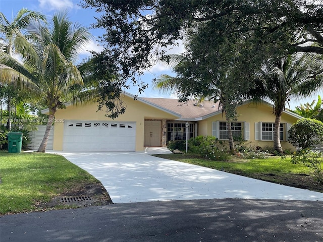 14409 SW 141st Pl, Miami, FL 33186 - ranch-style home featuring stucco siding, an attached garage, driveway, and a front yard
