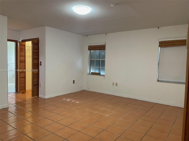14409 SW 141st Pl, Miami, FL 33186 - unfurnished room featuring light tile patterned floors and baseboards