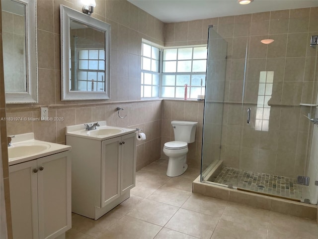14409 SW 141st Pl, Miami, FL 33186 - full bath featuring tile walls, two vanities, a shower stall, and tile patterned flooring