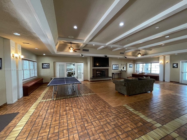 14409 SW 141st Pl, Miami, FL 33186 - playroom with ceiling fan, beamed ceiling, a brick fireplace, and recessed lighting