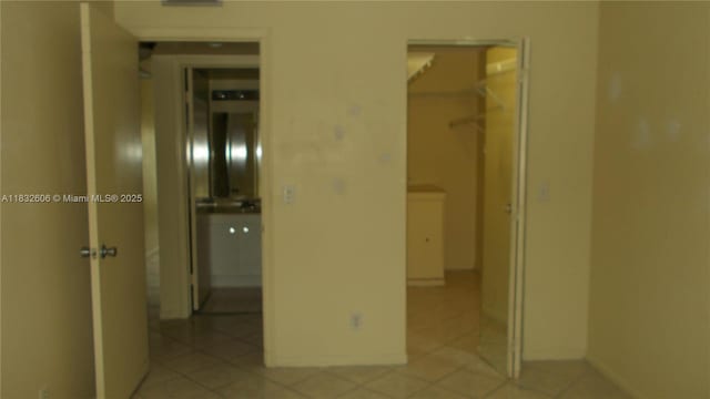 13550 SW 6th Ct Unit 208A, Pembroke Pines, FL 33027 - unfurnished bedroom with a spacious closet, light tile patterned flooring, and a closet