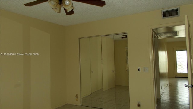 13550 SW 6th Ct Unit 208A, Pembroke Pines, FL 33027 - unfurnished bedroom featuring a closet, a textured ceiling, a ceiling fan, and light tile patterned floors