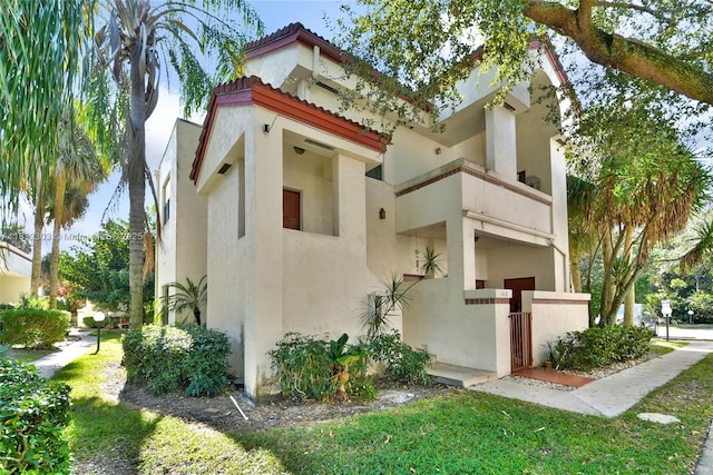 1419 Avon Ln Unit 216, North Lauderdale, FL 33068 - view of property exterior featuring stucco siding and a tiled roof