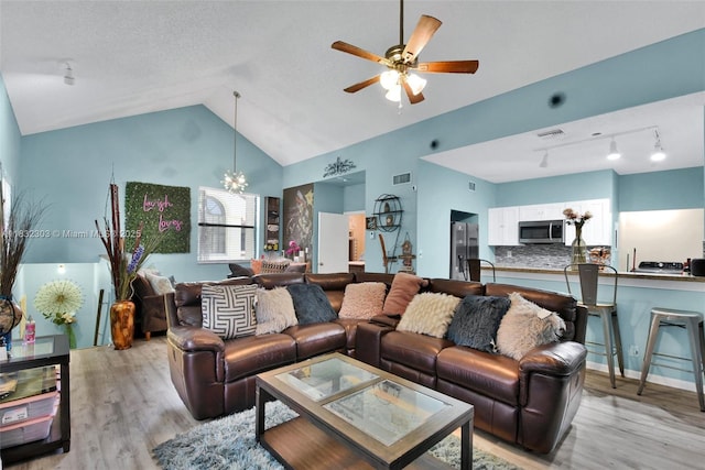 1419 Avon Ln Unit 216, North Lauderdale, FL 33068 - living room featuring light wood-type flooring, vaulted ceiling, a chandelier, and ceiling fan
