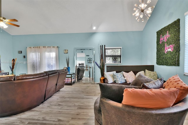 1419 Avon Ln Unit 216, North Lauderdale, FL 33068 - living area with lofted ceiling, ceiling fan, light wood-style floors, and a chandelier
