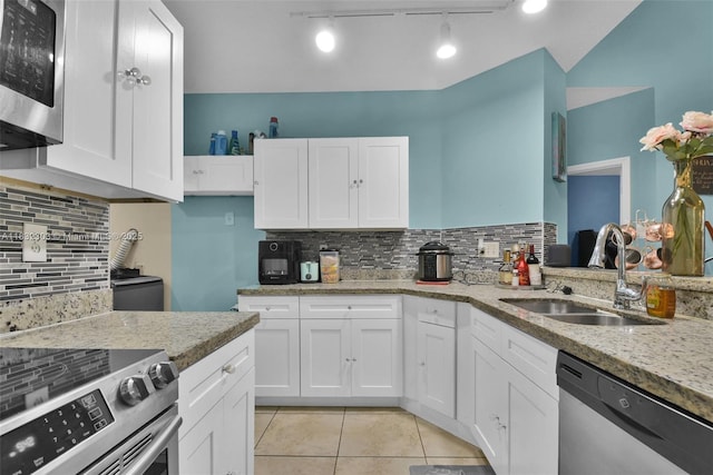 1419 Avon Ln Unit 216, North Lauderdale, FL 33068 - kitchen featuring stainless steel appliances, tasteful backsplash, light tile patterned floors, light stone counters, and white cabinets