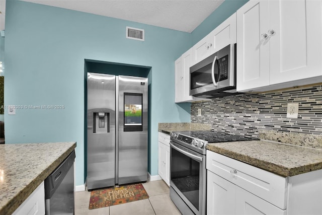 1419 Avon Ln Unit 216, North Lauderdale, FL 33068 - kitchen featuring stainless steel appliances, backsplash, white cabinets, and light tile patterned flooring