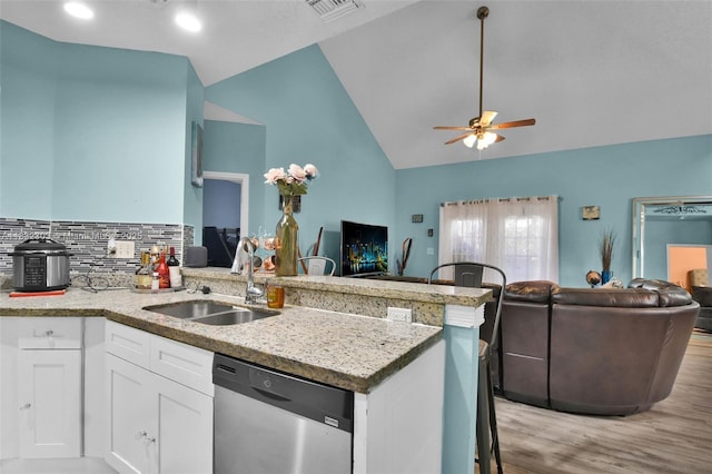 1419 Avon Ln Unit 216, North Lauderdale, FL 33068 - kitchen featuring stainless steel dishwasher, open floor plan, a ceiling fan, light wood-style floors, and high vaulted ceiling