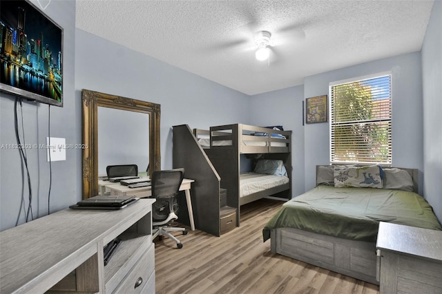 1419 Avon Ln Unit 216, North Lauderdale, FL 33068 - bedroom featuring wood finished floors, a textured ceiling, a desk, and ceiling fan