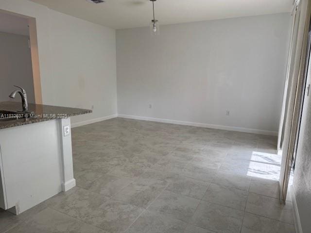 5013 Vulcan Way, Davie, FL 33314 - unfurnished dining area with baseboards and a sink