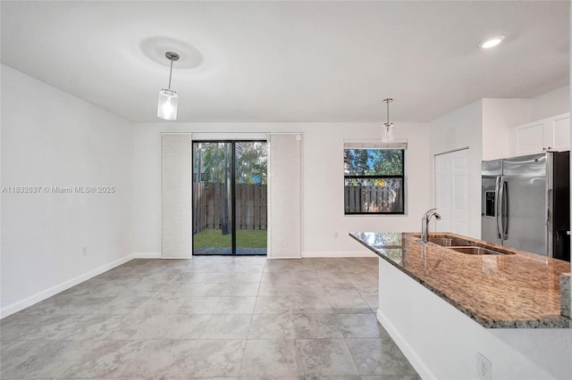 5013 Vulcan Way, Davie, FL 33314 - kitchen featuring stainless steel fridge, stone countertops, hanging light fixtures, and white cabinetry