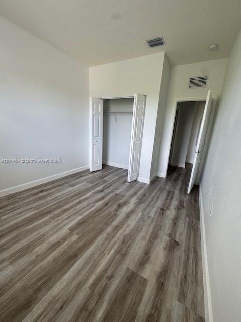 5013 Vulcan Way, Davie, FL 33314 - unfurnished bedroom featuring dark wood finished floors and a closet