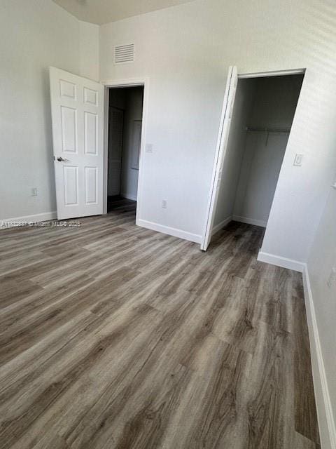 5013 Vulcan Way, Davie, FL 33314 - unfurnished bedroom featuring wood finished floors and a spacious closet