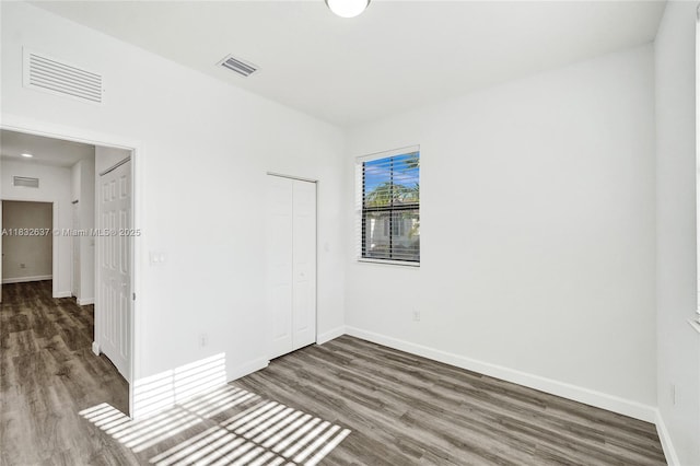 5013 Vulcan Way, Davie, FL 33314 - unfurnished bedroom with wood finished floors and a closet