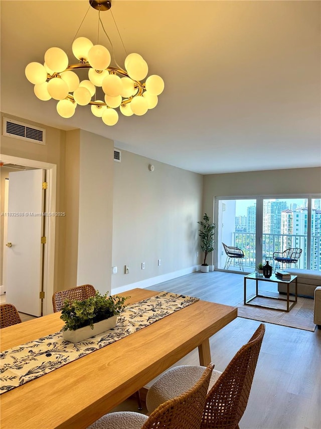 300 Bayview Dr Unit 1801, Sunny Isles Beach, FL 33160 - dining area featuring wood finished floors and a chandelier