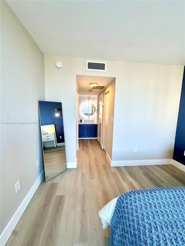 300 Bayview Dr Unit 1801, Sunny Isles Beach, FL 33160 - unfurnished bedroom featuring light wood finished floors and baseboards