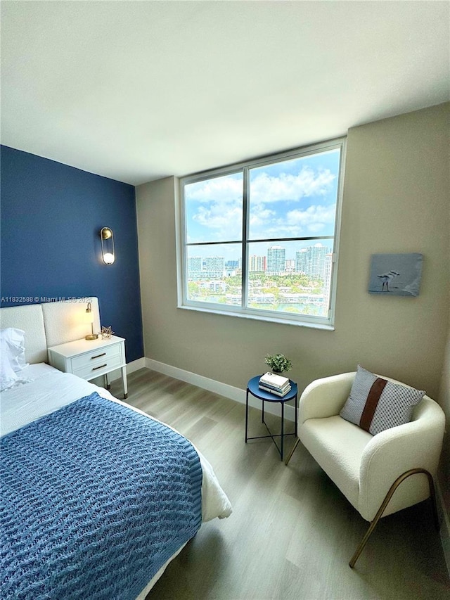 300 Bayview Dr Unit 1801, Sunny Isles Beach, FL 33160 - bedroom featuring light wood-type flooring and baseboards
