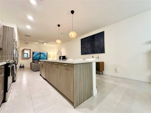 8031 NW 104th Ave Unit 21, Doral, FL 33178 - kitchen with stainless steel appliances, open floor plan, light countertops, light tile patterned flooring, and modern cabinets