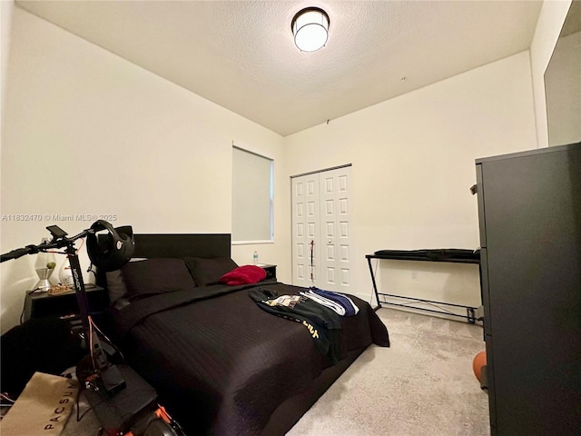 8031 NW 104th Ave Unit 21, Doral, FL 33178 - carpeted bedroom featuring a closet and a textured ceiling