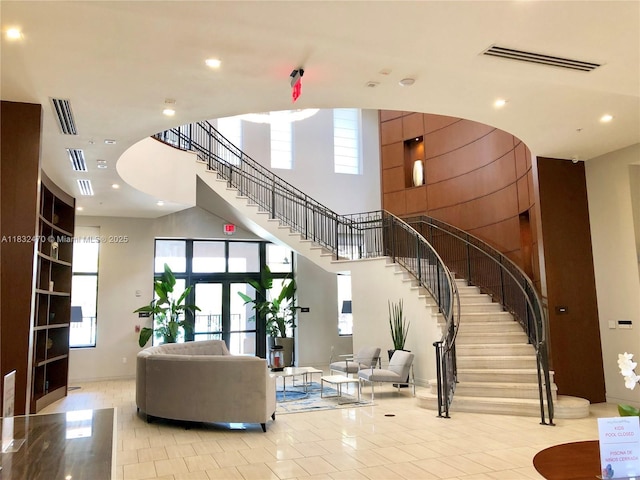 8031 NW 104th Ave Unit 21, Doral, FL 33178 - building lobby with a towering ceiling, stairs, and recessed lighting