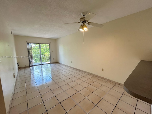 3181 SW 13th St Unit 401, Miami, FL 33145 - spare room featuring light tile patterned flooring, ceiling fan, and a textured ceiling