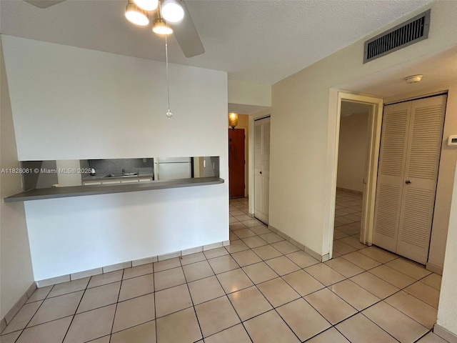 3181 SW 13th St Unit 401, Miami, FL 33145 - kitchen with fridge, a ceiling fan, light tile patterned flooring, and dark countertops