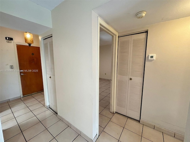 3181 SW 13th St Unit 401, Miami, FL 33145 - hallway with light tile patterned flooring