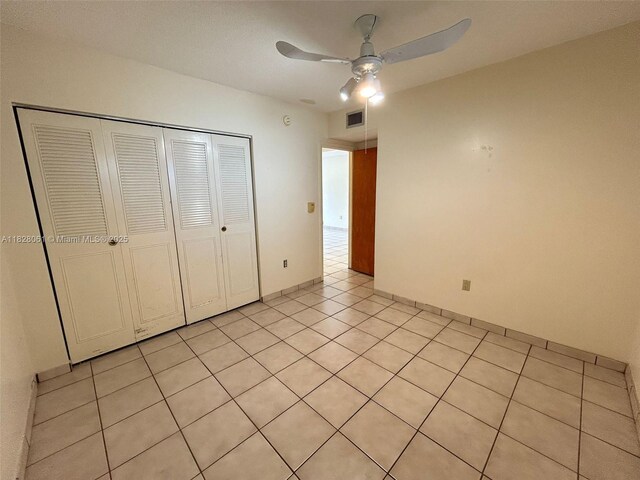 3181 SW 13th St Unit 401, Miami, FL 33145 - unfurnished bedroom featuring a closet, light tile patterned flooring, and a ceiling fan