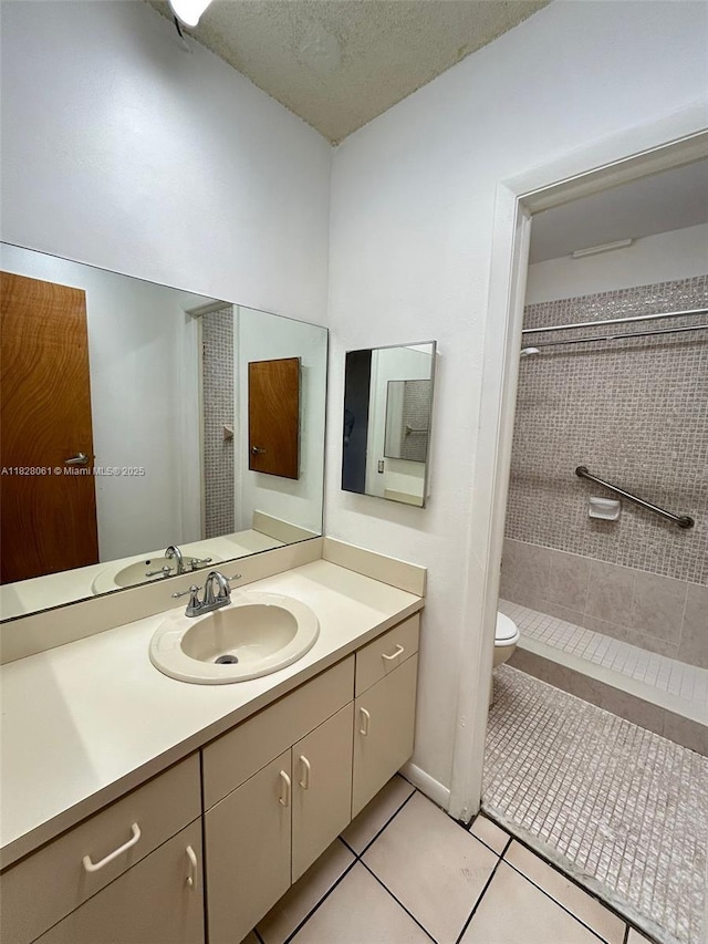 3181 SW 13th St Unit 401, Miami, FL 33145 - full bathroom with a stall shower, vanity, tile patterned flooring, and a textured ceiling