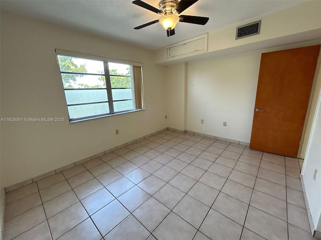 3181 SW 13th St Unit 401, Miami, FL 33145 - spare room featuring ceiling fan, light tile patterned floors, and a textured ceiling
