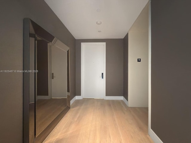 10201 Collins Ave Unit 1802, Bal Harbour, FL 33154 - hallway with light wood-style flooring and baseboards