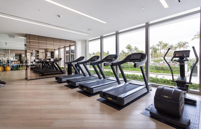 10201 Collins Ave Unit 1802, Bal Harbour, FL 33154 - exercise room featuring wood finished floors and floor to ceiling windows