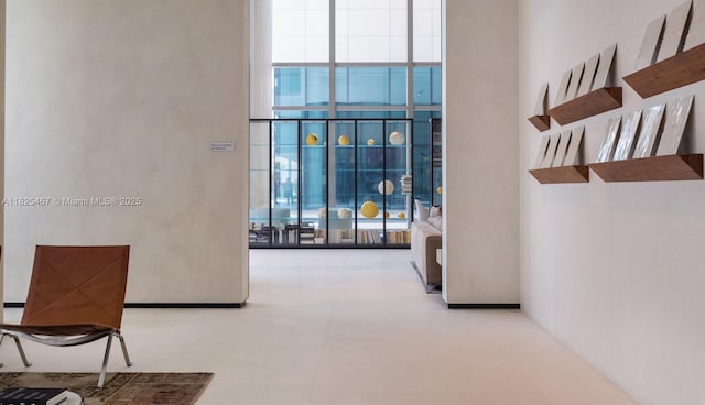 10201 Collins Ave Unit 1802, Bal Harbour, FL 33154 - corridor featuring expansive windows and a towering ceiling