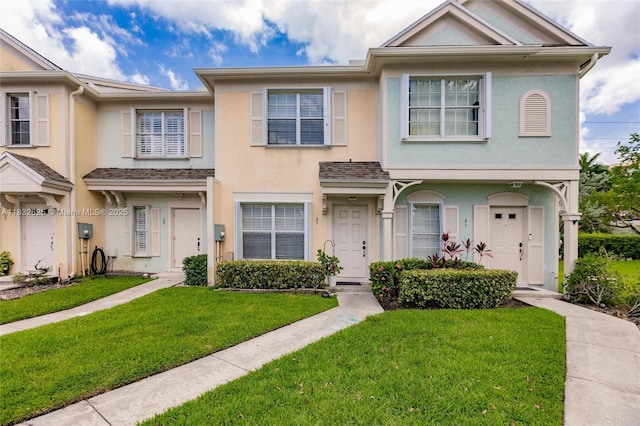 23 Simonton Cir, Weston, FL 33326 - townhome / multi-family property with stucco siding and a front lawn