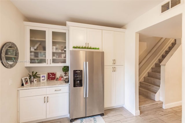 23 Simonton Cir, Weston, FL 33326 - kitchen with stainless steel fridge with ice dispenser, light countertops, white cabinetry, and glass insert cabinets