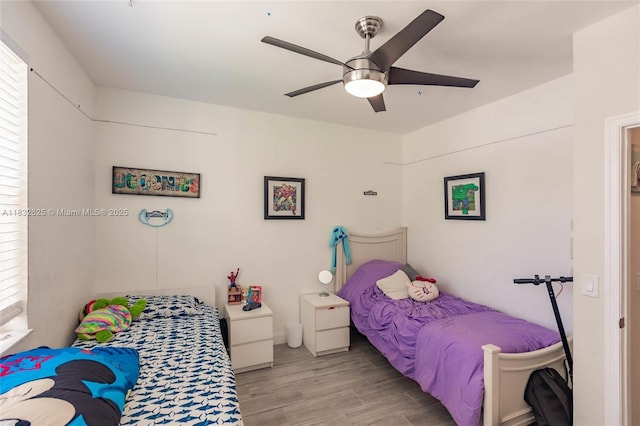 23 Simonton Cir, Weston, FL 33326 - bedroom with light wood finished floors, a ceiling fan, and multiple windows