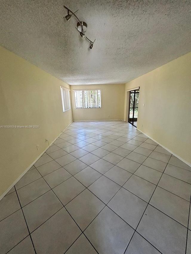 189 Lakeview Dr Unit 103, Weston, FL 33326 - spare room with a textured ceiling and light tile patterned floors