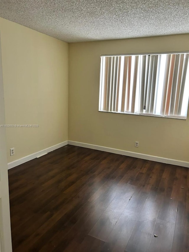 189 Lakeview Dr Unit 103, Weston, FL 33326 - unfurnished room featuring dark wood-type flooring and a textured ceiling
