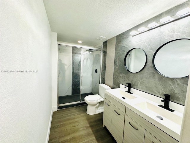 1962 Freeport Ln Unit 1962, Riviera Beach, FL 33404 - bathroom with wood finished floors, double vanity, a marble finish shower, a textured ceiling, and a textured wall
