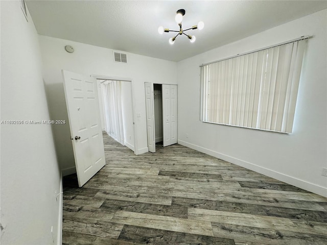 1962 Freeport Ln Unit 1962, Riviera Beach, FL 33404 - unfurnished bedroom with a chandelier and wood finished floors