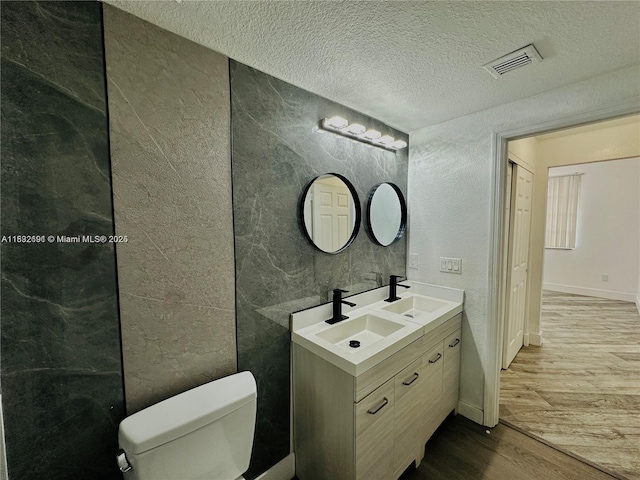 1962 Freeport Ln Unit 1962, Riviera Beach, FL 33404 - bathroom with wood finished floors, double vanity, and a textured ceiling